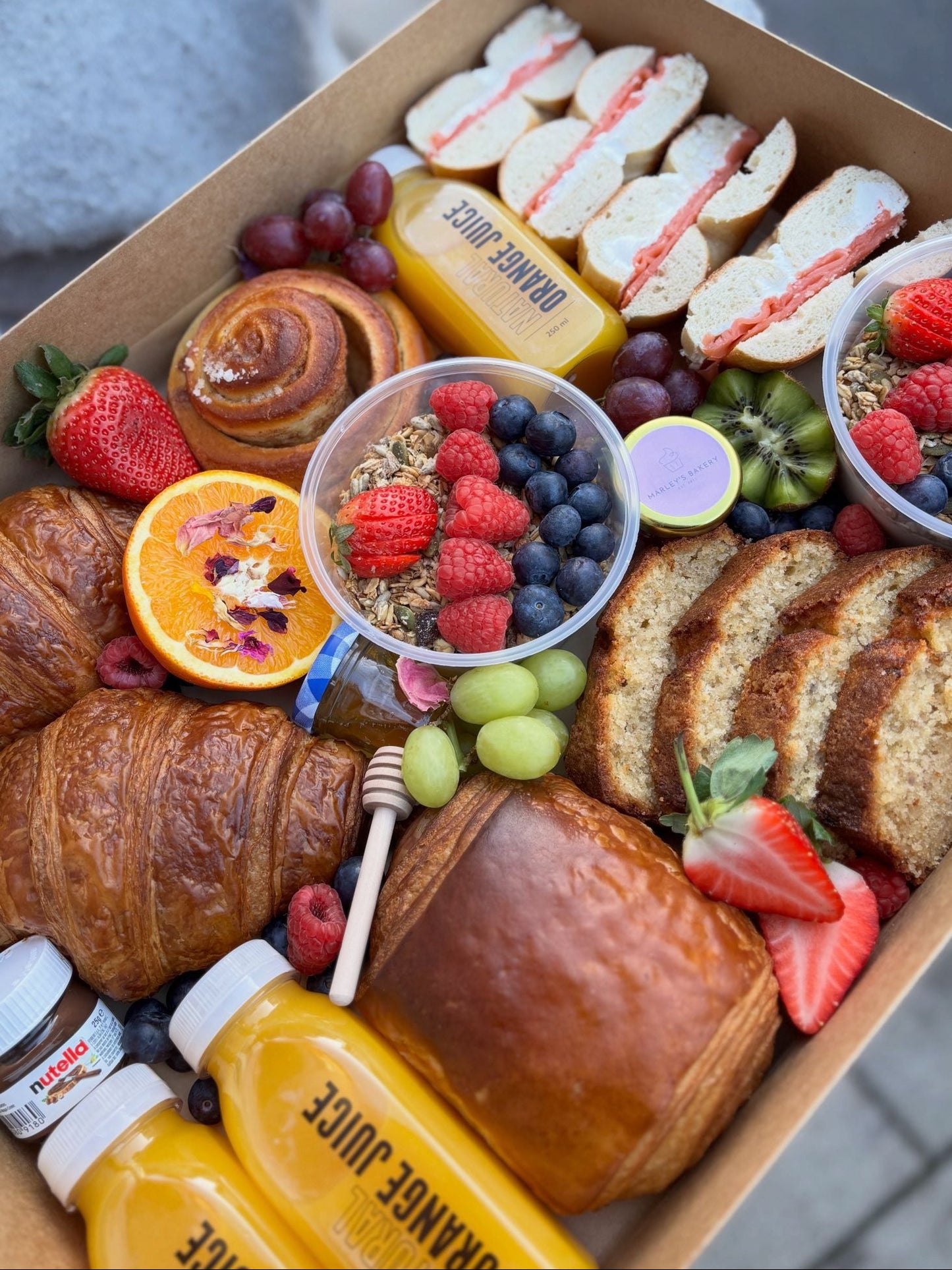 Breakfast box with croissants, fruit, pastries and fresh orange juice for local collection